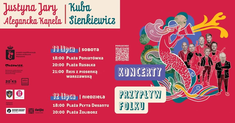 Tłum bawi się na wieczornym koncercie plenerowym przy ciepłym oświetleniu sceny, wykonawcy na scenie z efektami dymu i festiwalowymi banerami tworzącymi żywą atmosferę muzycznego wydarzenia